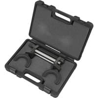 Black Sealey shock absorber spring compressor with U-shaped clamps in a hard plastic carrying case.