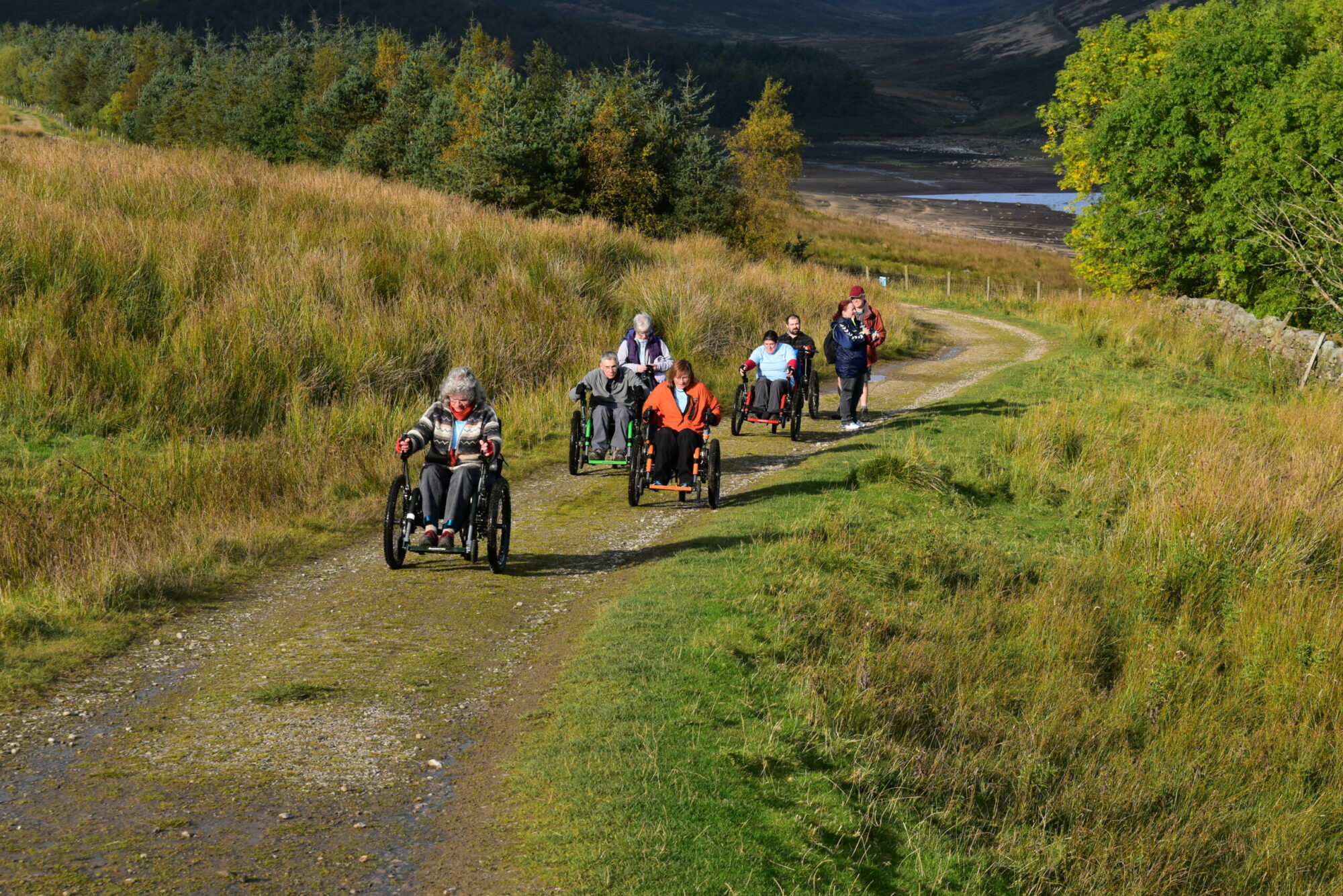 A group of people using Mountain Trike All-Terrain Wheelchairs at Yorkshire Water's Grimwith Reservoir.