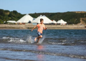 boy running through water