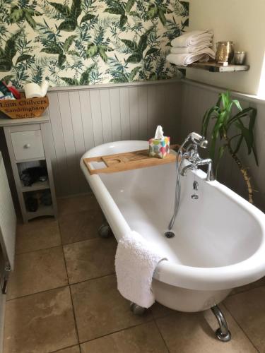 King size bed & en suite rolled top bath private lane image three
