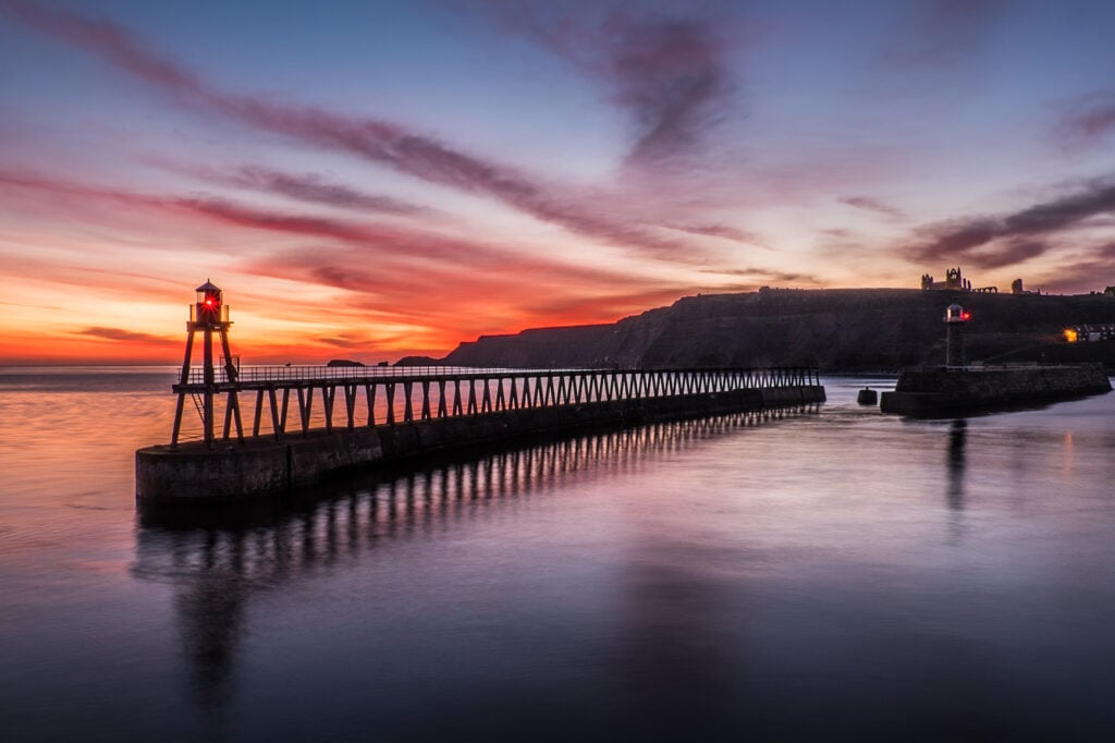 Image name whitby pier sunset the 2 image from the post Best places to propose in Yorkshire on Valentine's Day in Yorkshire.com.