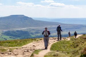 Image name walkers descending whernside view of ingleborough sunny yorkshire the 4 image from the post Northallerton in Yorkshire.com.