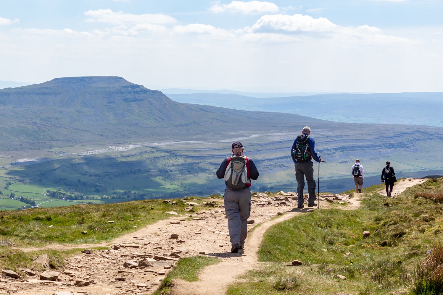 Image name walkers descending whernside view of ingleborough sunny yorkshire the 5 image from the post Stride Out in Yorkshire: Celebrate National Walking Day in Yorkshire.com.