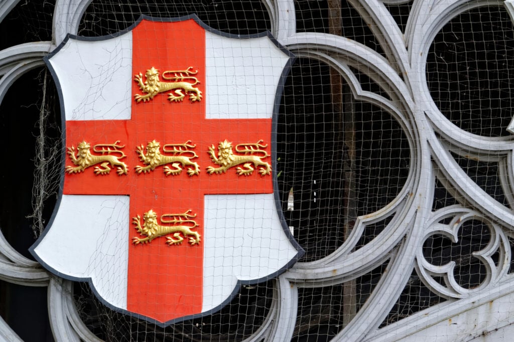 St. George crest from Skeldergate Bridge in York, UK spanning the River Ouse in winter. The bridge is an iron bridge with gothic details completed in 1881.