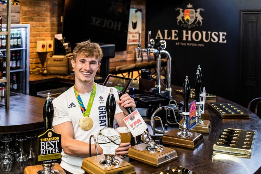 Image name The Ripon Inn. Jack Laugher pint pull the 8 image from the post THE INN COLLECTION GROUP PRESS RELEASE - Olympic champion Jack dives "inn" to mark Ripon re-opening in Yorkshire.com.