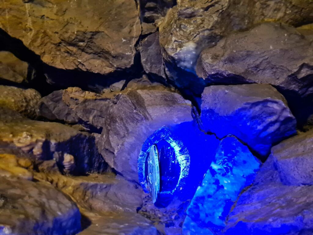 Image name fairy door under uv light stump cross caverns yorkshire the 5 image from the post Tune in Tonight: Stump Cross Caverns Features on "The Hotel Inspector" in Yorkshire.com.