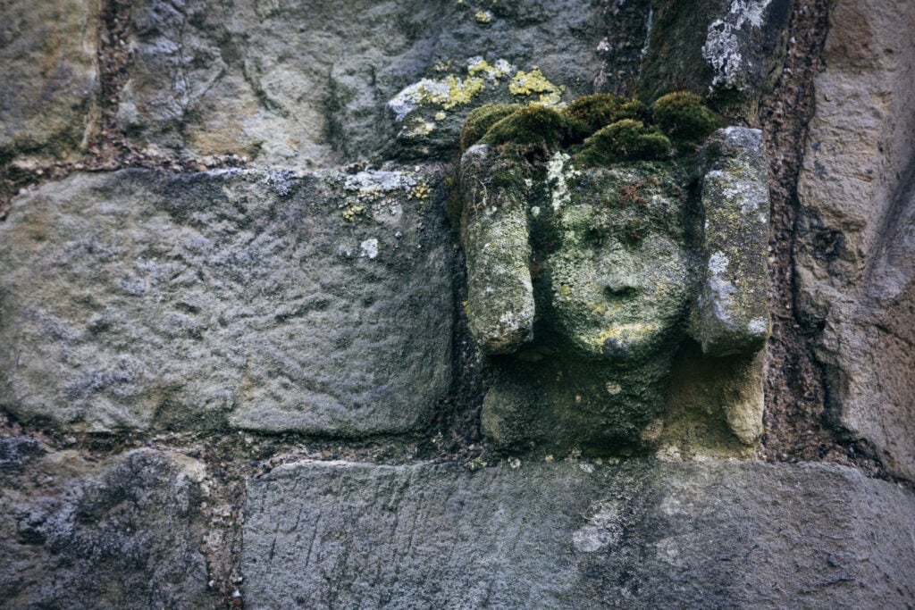 Image name wharram percy church stone carving face yorkshire the 2 image from the post A look at the history of Wharram Percy, with Dr Emma Wells in Yorkshire.com.