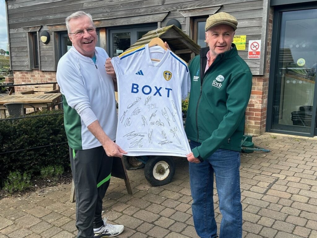 Image name Chris Mitchell and Karl Avison with the signed Leeds United shirt 1 the 1 image from the post Farmer's Cancer Fundraising Campaign Supported By Local Pocklington Businessman in Yorkshire.com.