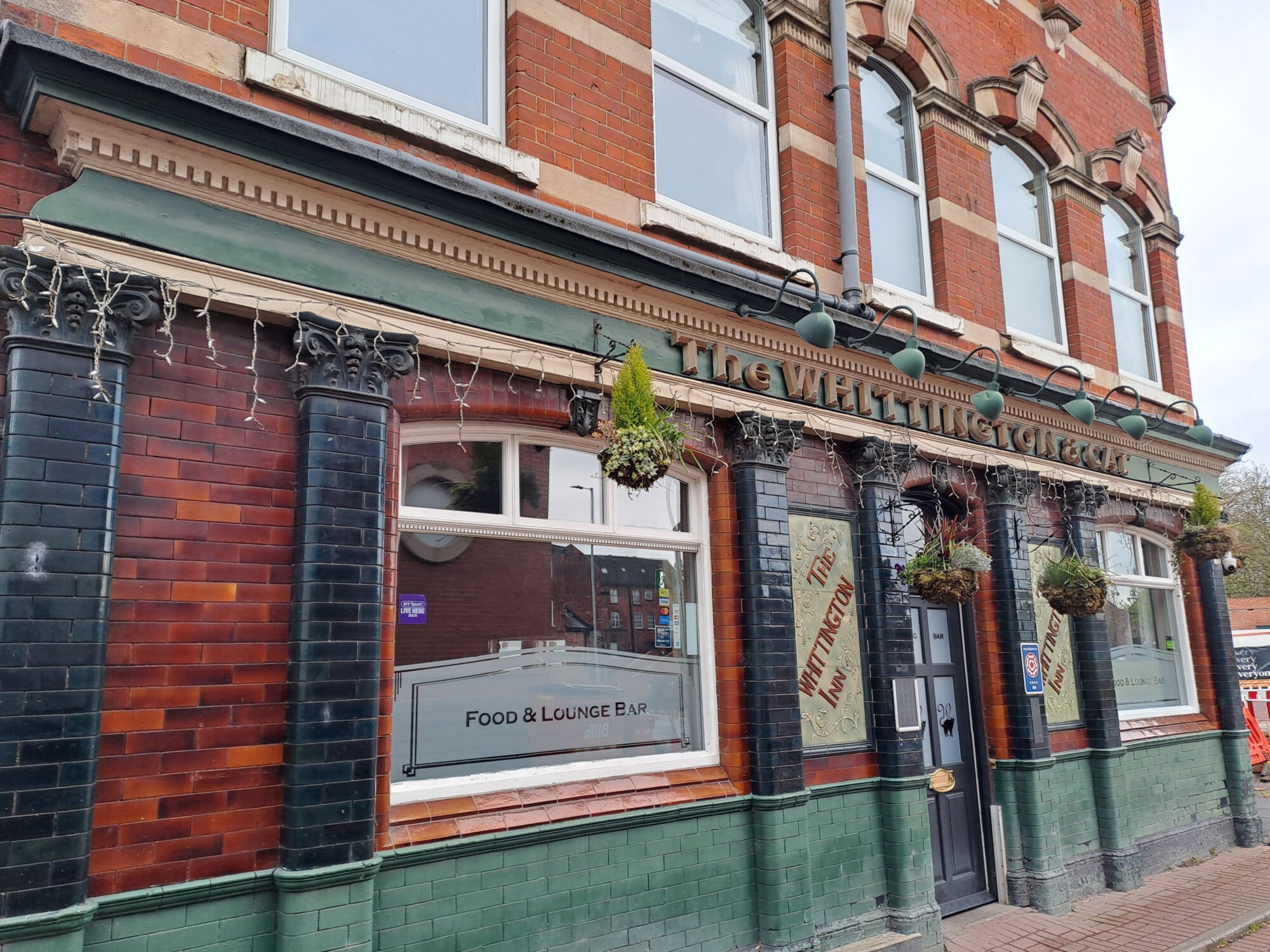 facade of Whittington & Cat Pub pun needing restoration work
